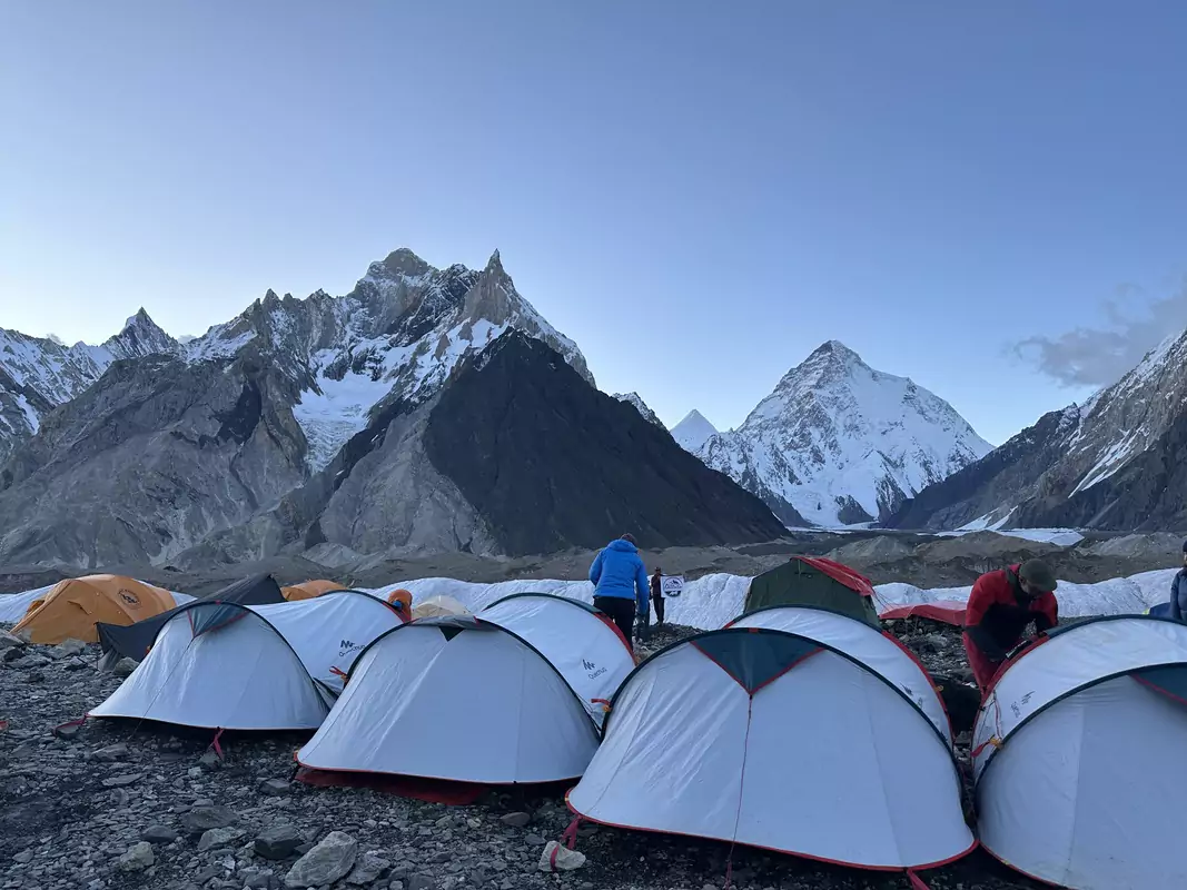Gondogoro La Pass with camping Tents set up at Gondogoro La Pass campsite surrounded by snow-covered peaks during the K2 and Gondogoro La Trek