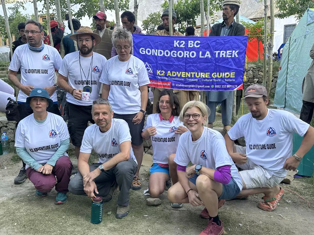 K2 adventure Guide trekers K2 Adventure guide and trekkers wearing branded shirts posing happily for a photo during the Gondogoro La Trek