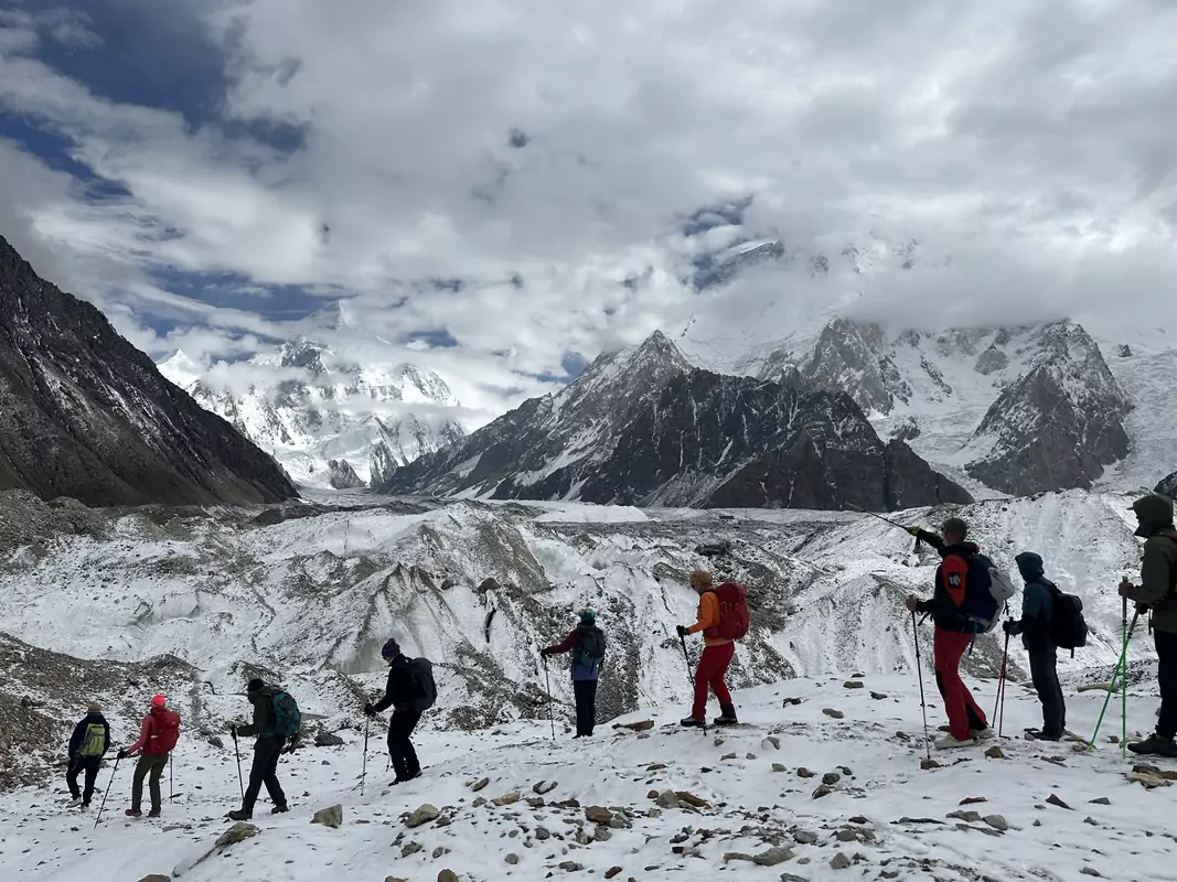 hikers-on-k2-gondogoro-la-trail. Adventurers hiking along the rugged K2 and Gondogoro La trail surrounded by dramatic mountain landscapes